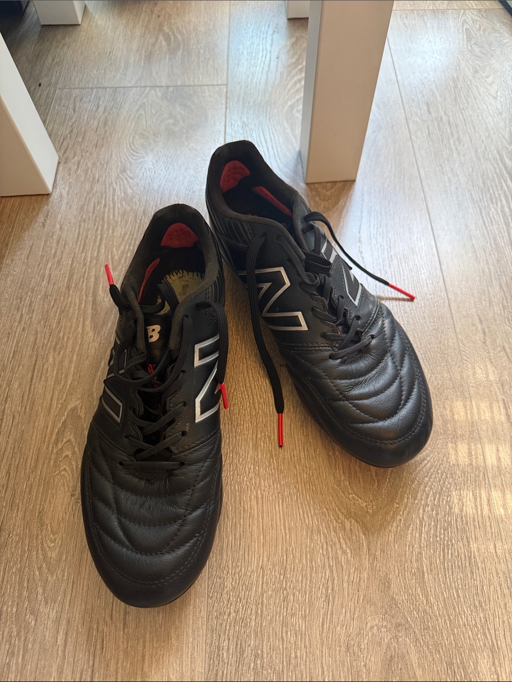 New Balance Men’s Black Athletic Soccer-Style Shoes with Red Accents